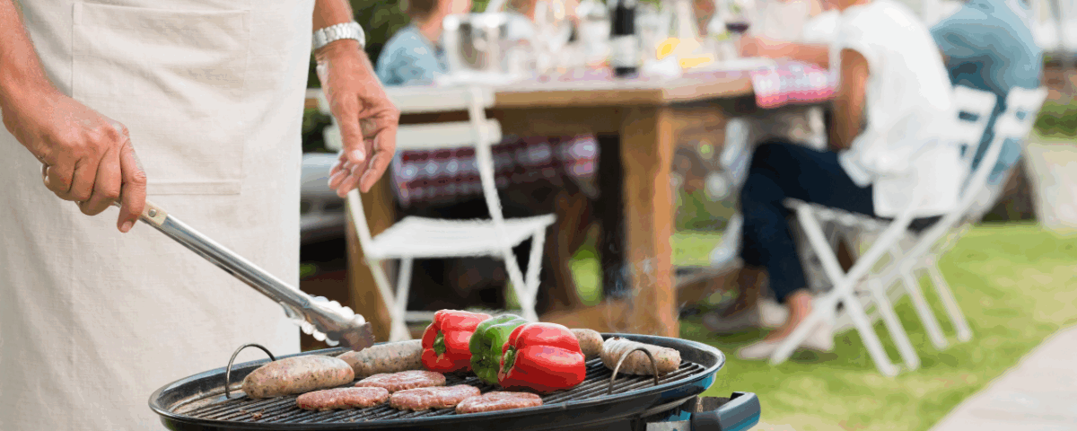 Person bbqing in their backyard